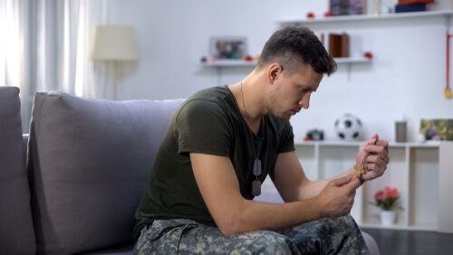 Veteran with emotional stress overcoming military stigmas to seek treatment for substance abuse and addiction.